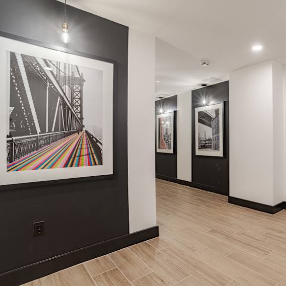 contemporary hallway with framed bridge artwork and pendant lighting at the yancey apartments, charlotte, 28217