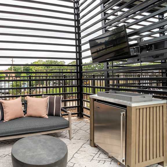 covered patio with outdoor kitchen and lounge seating at the yancey apartments, charlotte, north carolina