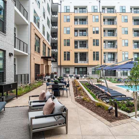 courtyard with pool lounge seating and landscaped gardens at the yancey apartments, charlotte, nc