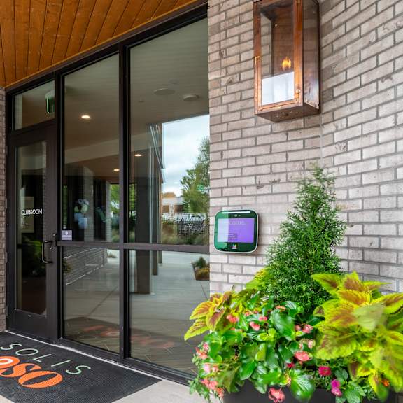 building entrance with keypad access and welcome mat at the yancey apartments, charlotte, nc