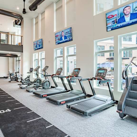 spacious fitness center with treadmills and stationary bikes at the yancey apartments, charlotte
