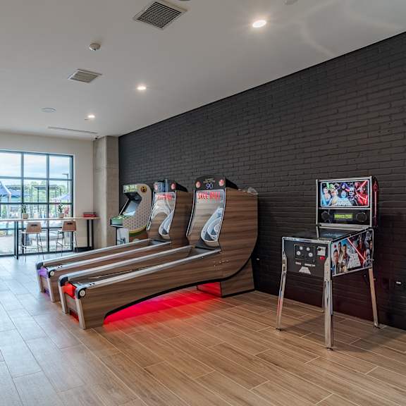 game room with skee ball and arcade machine at the yancey apartments, north carolina