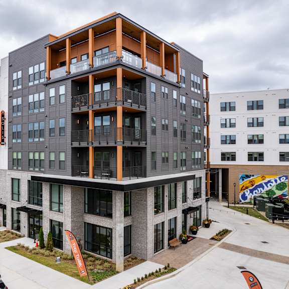 modern apartment complex with orange accent framing and balconies at the yancey apartments, charlotte, north carolina