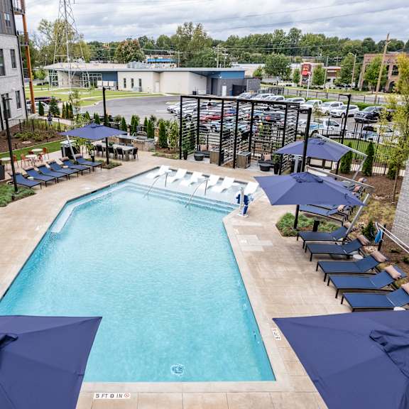 outdoor pool with tanning ledge and cabana seating at the yancey apartments, north carolina, 28217
