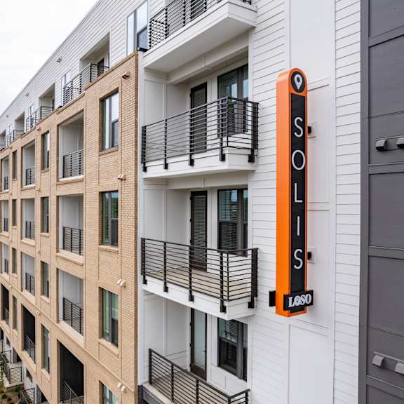 modern apartment exterior with vertical branded signage at the yancey apartments, charlotte, 28217