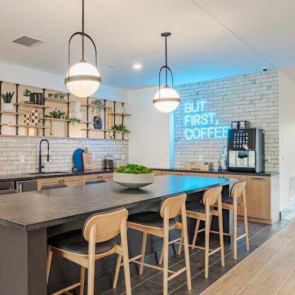 community kitchen with island seating and coffee bar at the yancey apartments, charlotte, north carolina