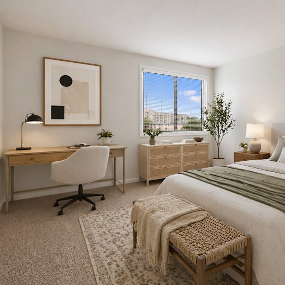 a bedroom with a large bed, a desk with a chair, and a window overlooking a cityscape.