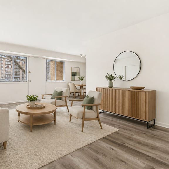 a living room with a white sofa, a wooden coffee table, and a white chair.