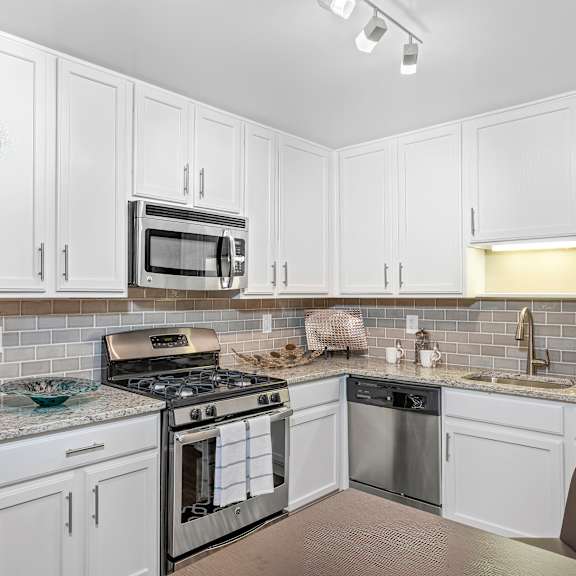 modern kitchen with stainless steel appliances and double door refrigerators at versailles apartments, towson, 21204