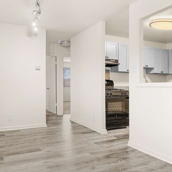 a spacious kitchen with white cabinets and a wooden floor at seven springs apartments, college park