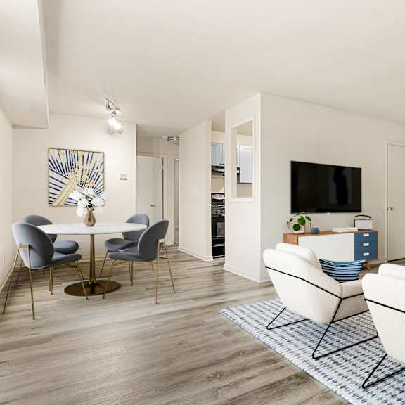 a living room with a white table and blue couch at seven springs apartments, college park