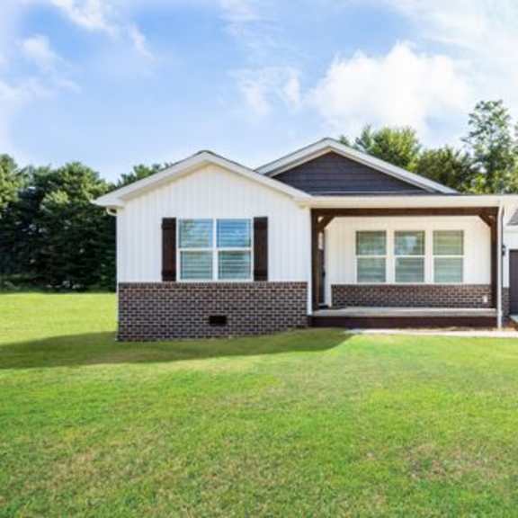 a house with a garage and a green lawn