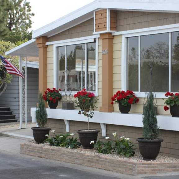 a house with red flowers in front of it