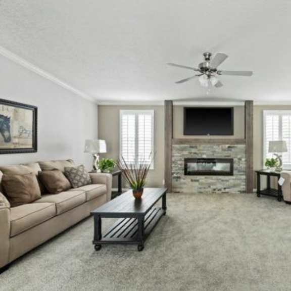 a living room filled with furniture and a fireplace