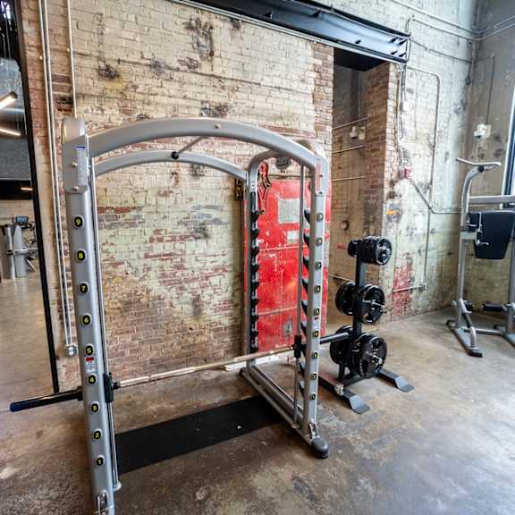 a gym with a brick wall and a red door in the background at conwood flats, memphis, tn