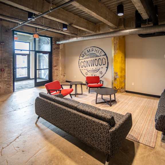 a room with couches chairs and a logo on the wall at conwood flats, memphis, tennessee