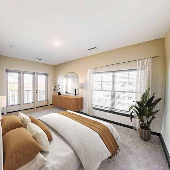 a bedroom with a large bed and a window overlooking a balcony at harbor side at conwood flats apartments in uptown memphis, tn