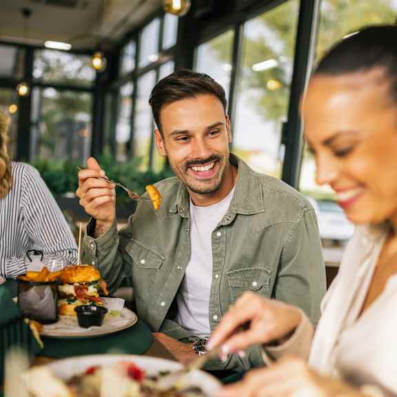 A man and a woman are enjoying a meal together At The Dawson Cartersville in Cartersville, GA, 30121