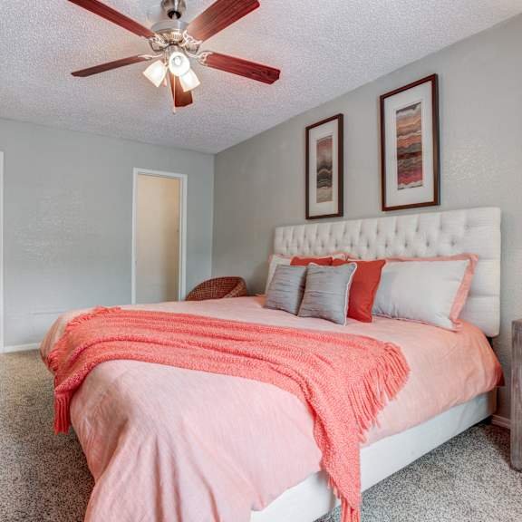 bedroom with a bed and a ceiling fan at sausalito apartments, college station, 77840