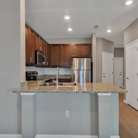 a kitchen with an island and stainless steel appliances