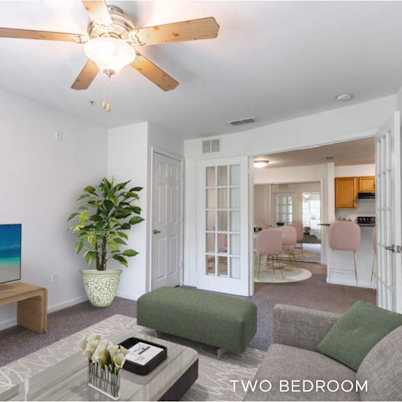 a living room with a flat screen tv and a plant.