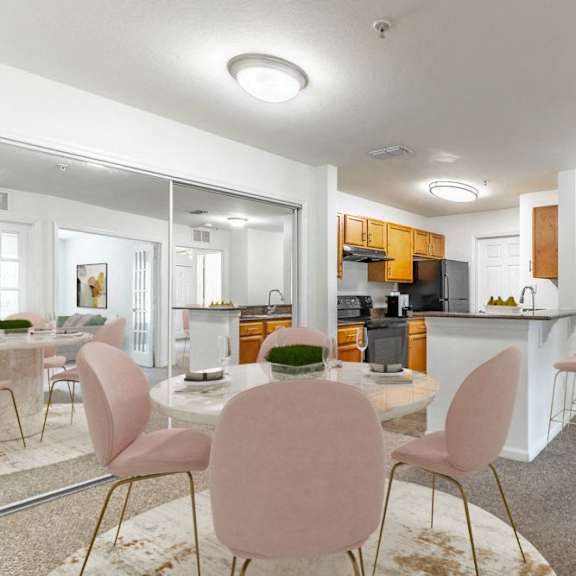 a dining room and kitchen with a table and chairs