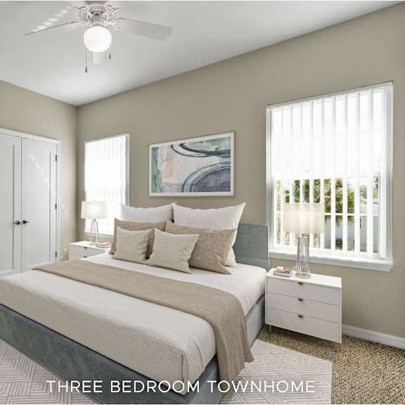 a bedroom with a bed, a ceiling fan, and a painting on the wall.