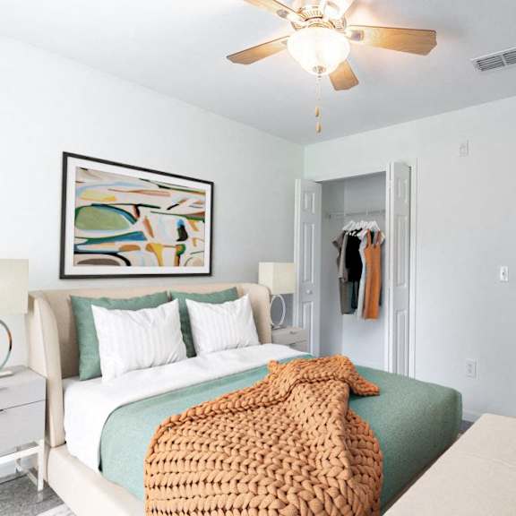 a bedroom with a bed and a ceiling fan