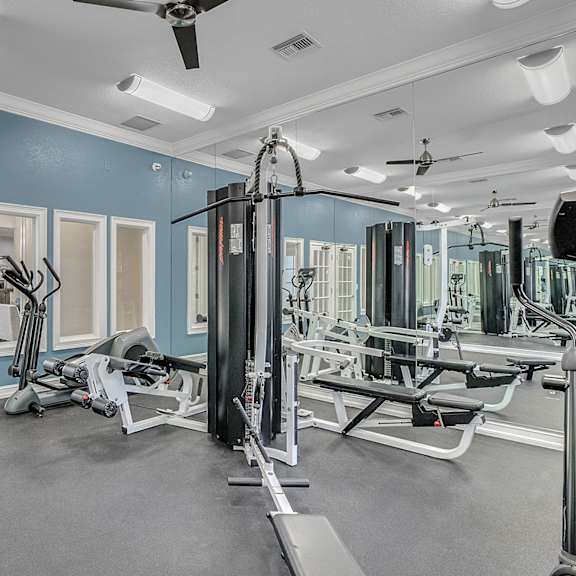 fitness center with equipment and mirror