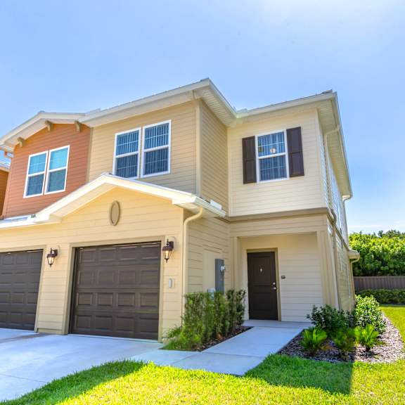 a house with two garages and a lawn