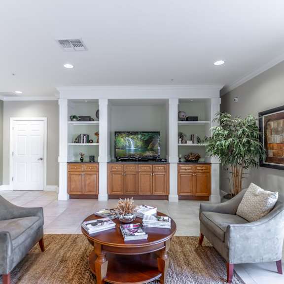 a living room filled with furniture and a flat screen tv