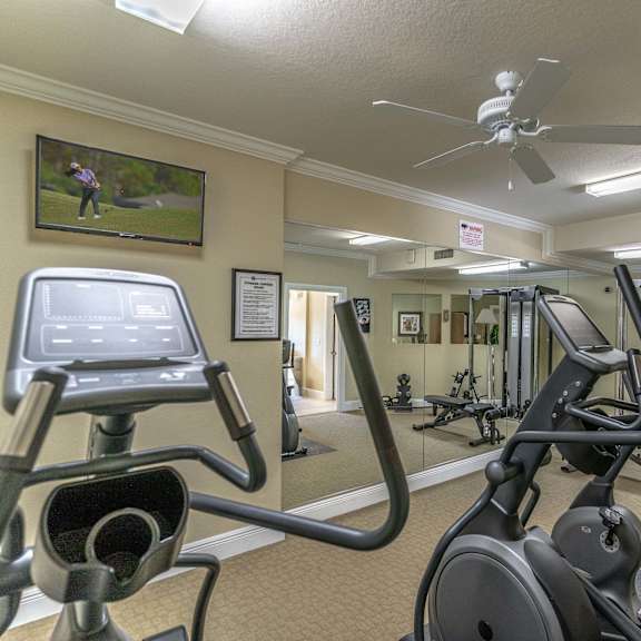 a room filled with lots of different types of exercise equipment
