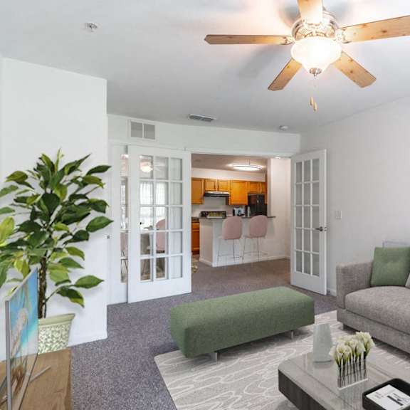 a living room with a couch and a ceiling fan