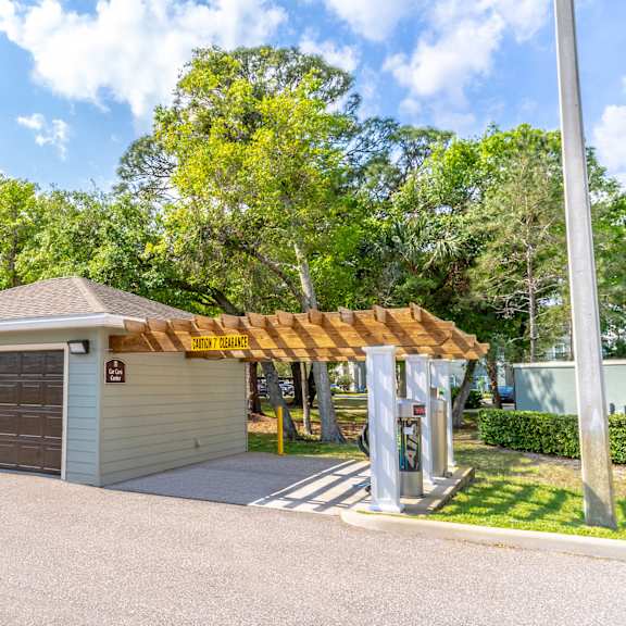 a small car care center with a garage and a pergola