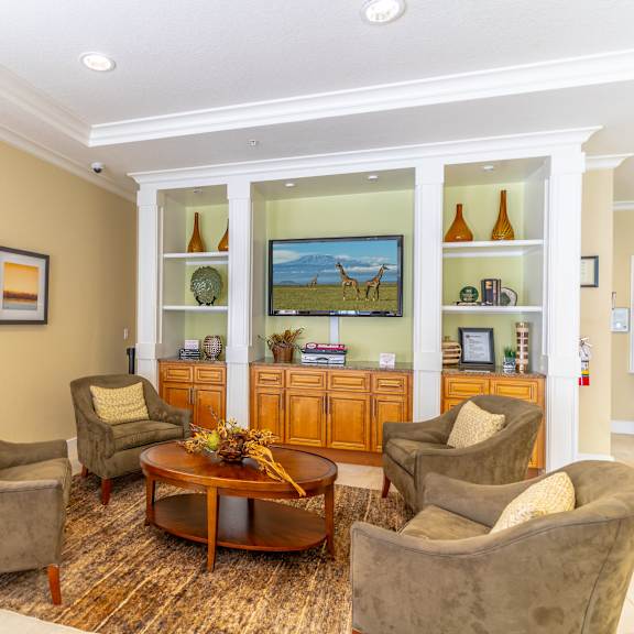 a clubhouse filled with furniture and a flat screen tv