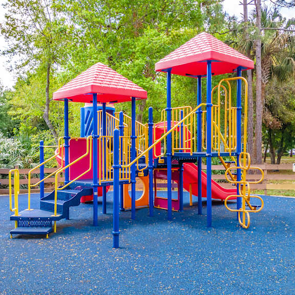 a colorful playground with slides and monkey bars