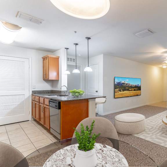 a living room with a kitchen and dining area
