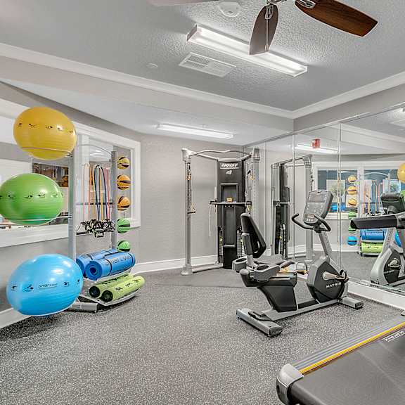 fitness center with equipment and mirror