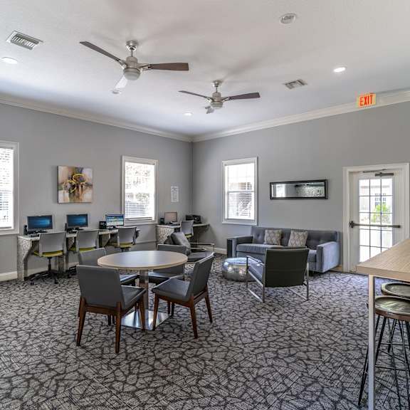 a room with couches and chairs and a table and chairs