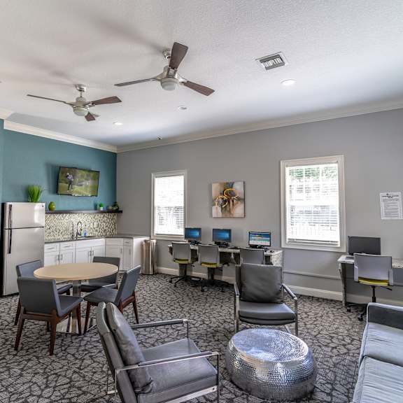 a room with couches and chairs and a table and chairs