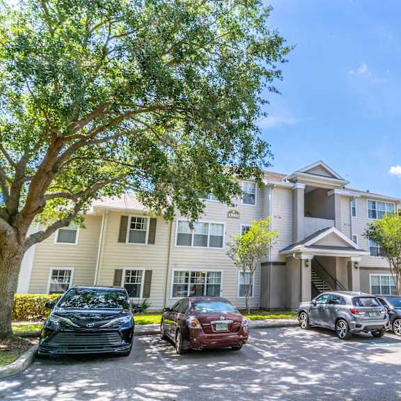 a large apartment building with a parking lot in front of it