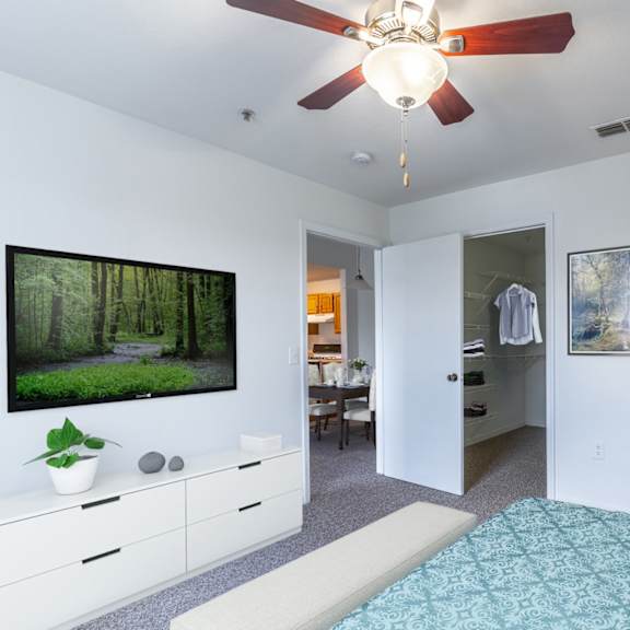 a bedroom with a bed and a ceiling fan