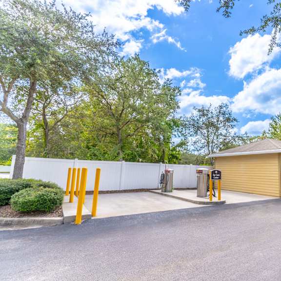 a yellow garage with a car parked in front of it