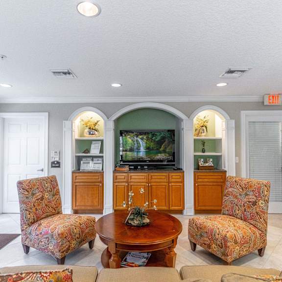 a living room with couches and a table and a television