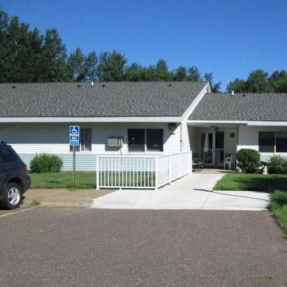 a white building with a black car parked in front.