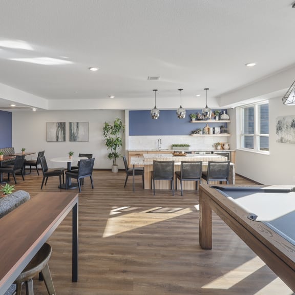 a clubroom with a pool table and a dining table