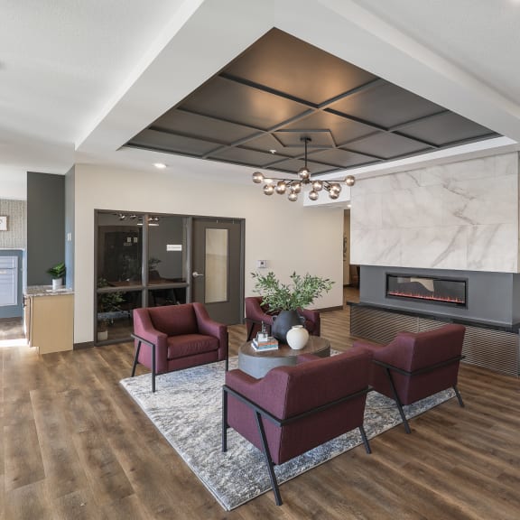 a large lobby area with a fireplace and couches
