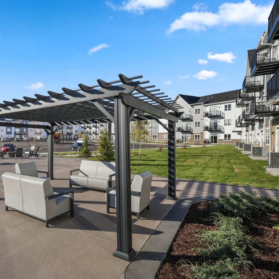 a patio with chairs and a table under awning