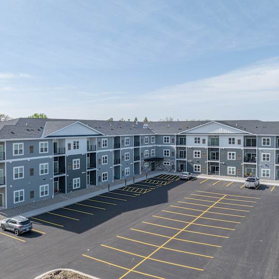 a large apartment building sitting in a parking lot
