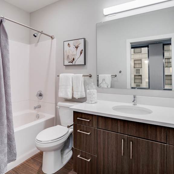 a white toilet sits in a bathroom with a brown cabinet.